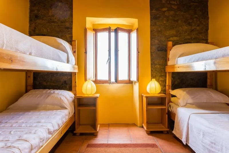 The bunk room, two sets of bunks either side of a shuttered window.